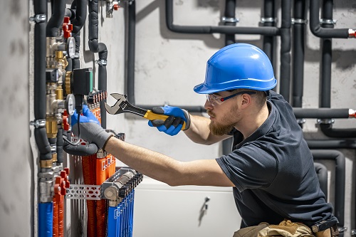 Handicore technician-checking-heating-system-boiler-room